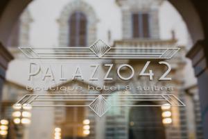 a sign for a hotel in front of a building at Palazzo 42 - Boutique Hotel & Suites in Pistoia