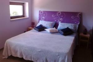 a bedroom with a large white bed with blue pillows at Residenza Flores in Pescara