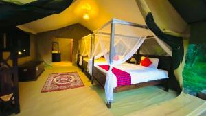 a bedroom with a canopy bed in a room at Lorian safari camp limited in Narok