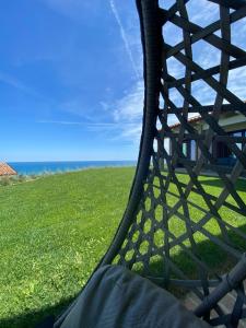 a person laying on a hammock in a field of grass at Casale Adriatico B&B in Pineto