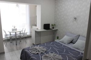 - une chambre avec un lit, un bureau et une table dans l'établissement Apartments in Kharkiv, à Kharkov