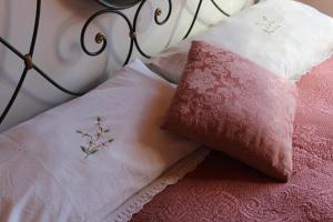 a bed with two pillows on top of it at agriturismo il poderetto in Licciana Nardi