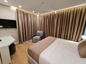 Letto o letti in una camera di Hotel Aross