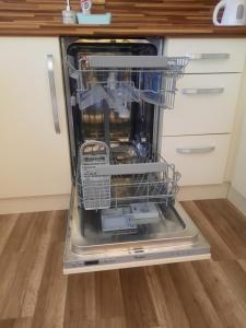 a dishwasher with its door open in a kitchen at Apartmán Sandra in Valtice