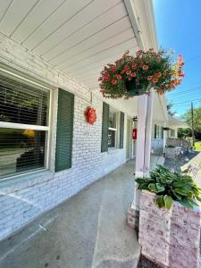 a house with a flower pot on the front of it at Geneva Hotel & Tiki Bar in Lake Lure