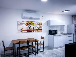 a kitchen with a table and chairs in a room at City Apartments in Eilat
