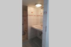 a bathroom with a sink and a toilet at petit studio pour une personne à Lobsann in Lobsann