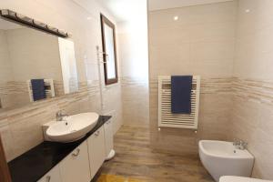 a white bathroom with a sink and a toilet at Borgo Antico in Diso