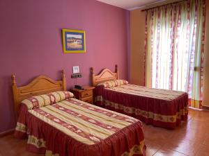 Łóżko lub łóżka w pokoju w obiekcie Quéntar Hotel Rural