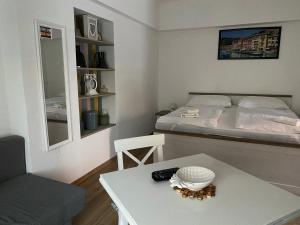 a small room with a bed and a table at Home Sweet Apartment in Bük