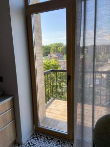 a glass door with a view of a balcony at Lux appartments в центре города в стиле Loft in Vinnytsya