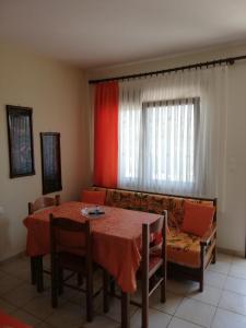 a living room with a table and a couch at Corner house in Leptokaria