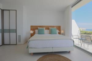 a bedroom with a bed and a balcony at Son Serra Sea Coast Villa in Son Serra de Marina