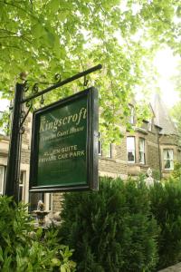 a sign in front of a brick building at Kingscroft in Buxton