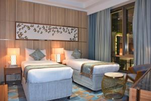 Katil atau katil-katil dalam bilik di Midan Hotel & Suites Al Aziziya