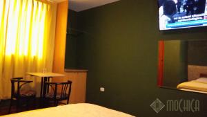 Letto o letti in una camera di Hostal Residencial Mochica