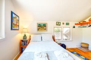a bedroom with a large bed and a window at Hillside Oak in Chilmark +30 photos