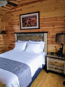 a bedroom with a bed and a wooden wall at Buckhorn RV Park & Resort in Huntington
