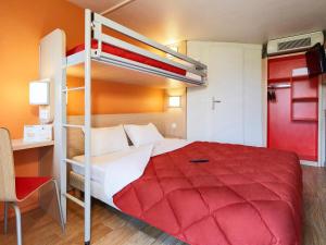1 dormitorio con litera y colcha roja en Premiere Classe Dijon Sud - Marsannay, en Marsannay-la-Côte
