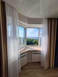 a room with a large window with a view at Baltic Sunset Apartments in Sillamäe