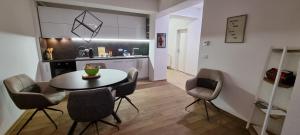 a kitchen and dining room with a table and chairs at Svir Deluxe Apartment No 8 in Ohrid
