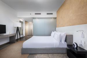 A bed or beds in a room at The G Hotel Seashell