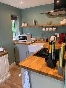 a kitchen with a counter top with a microwave at Alt-an Retreat Lodge overlooking loch linnhe in Fort William