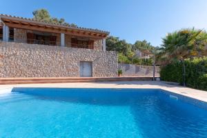 a swimming pool in front of a villa at Es Flavo in Sineu