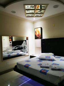 1 dormitorio con 2 camas y una foto en la pared en SP Hotel & Motel, en Mogi Mirim