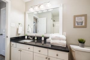a bathroom with a sink and a large mirror at Cute Condo in Rock Hill-49 in Rock Hill +21 photos