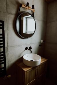 a bathroom with a sink and a mirror at Domki Ciszy Mi Daj in Wisła