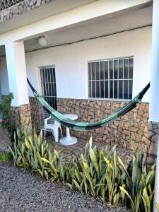 a hammock in front of a house at Ap01-A 50 Metros da Praia Flats Mobiliados para 4 Pessoas in Paulista