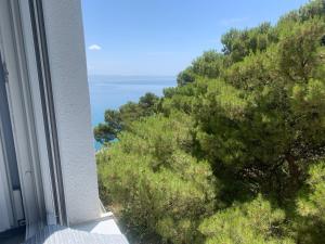a view of the ocean from the balcony of a building at Hotel Elu Iris in Split