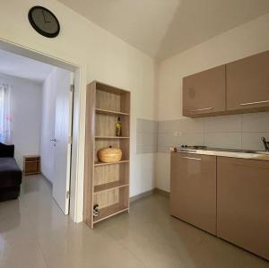 a kitchen with a counter and a clock on the wall at OSA Holiday in Ulcinj
