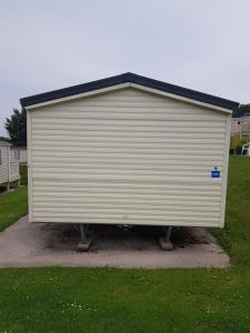 a large white roll up garage on the grass at Hoburne Devon Holidays Park Sleep 6 Caravan in Paignton