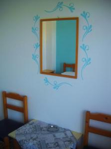 a mirror on the wall of a bedroom at Magdalini in Votsi