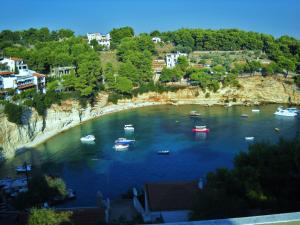 a group of boats in a large body of water at Magdalini in Votsi