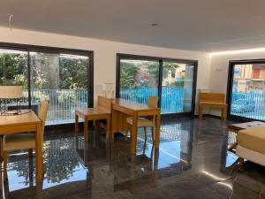 a dining room with a table and chairs and windows at KEFA SUITE in Cefalù