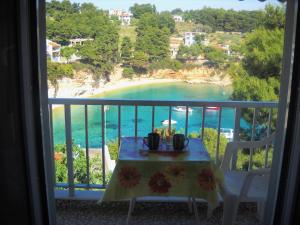 a balcony with a table and a view of a beach at Magdalini in Votsi