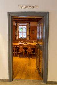 an open door into a dining room with a table at Hotel Alpin Tyrol - Kitzbüheler Alpen in Sankt Johann in Tirol