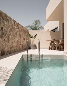 a swimming pool in the middle of a house at Seven Rocks in Paliouri