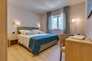 Postel nebo postele na pokoji v ubytování Residence Bepi Malugio