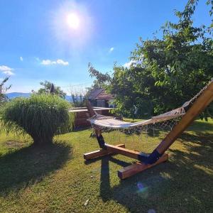 a hammock on the grass in a yard at ZOĆEVIĆA KONAK in Petrovići