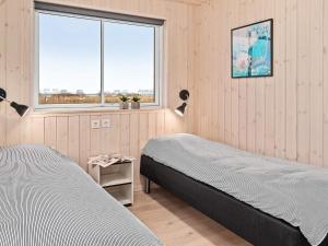 a bedroom with two beds and a window at 18 person holiday home in Hasselberg in Kappeln