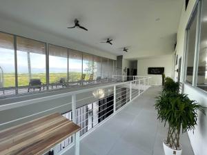 a building with a balcony with benches and windows at Casa Paraiso Azul Ocean View in Camaronal