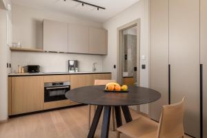 a kitchen with a table with a bowl of fruit on it at MAIORA Luxury Island Suites in Sali