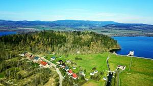 an aerial view of a village on a hill next to a lake at Agroturystyka Blicharzówka Noclegi in Bukówka