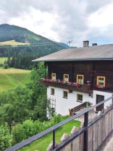 a house on the side of a hill at Apartment Familie Webhofer in Kartitsch