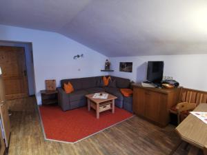 a living room with a couch and a table at Bauernhof Bethuber in Matrei in Osttirol