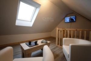 ein Wohnzimmer mit einem Sofa und einem Fenster in der Unterkunft Manoir Pors Braz B&B in Commana
